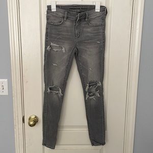 American Eagle Ne(x)t Level Stretch gray ripped skinny jeans.